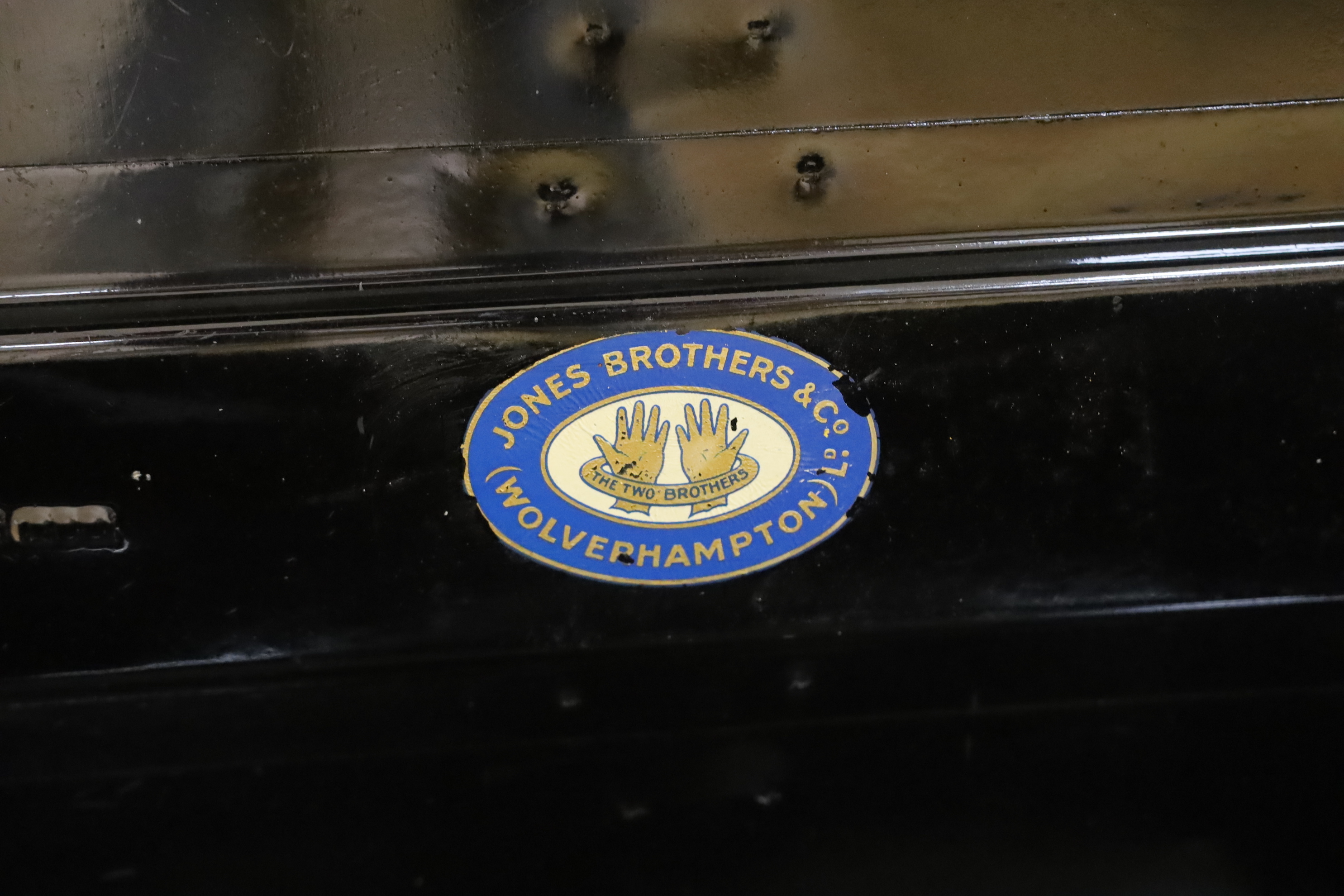 A black lacquered tin trunk, 68cm wide